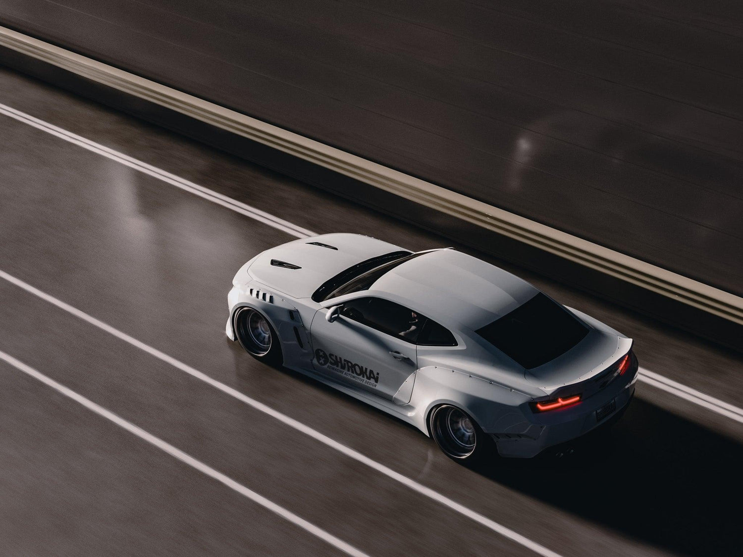 White Chevrolet Camaro 6th gen widebody kit SHIROKAI Stance lowered Chevy driving on highway