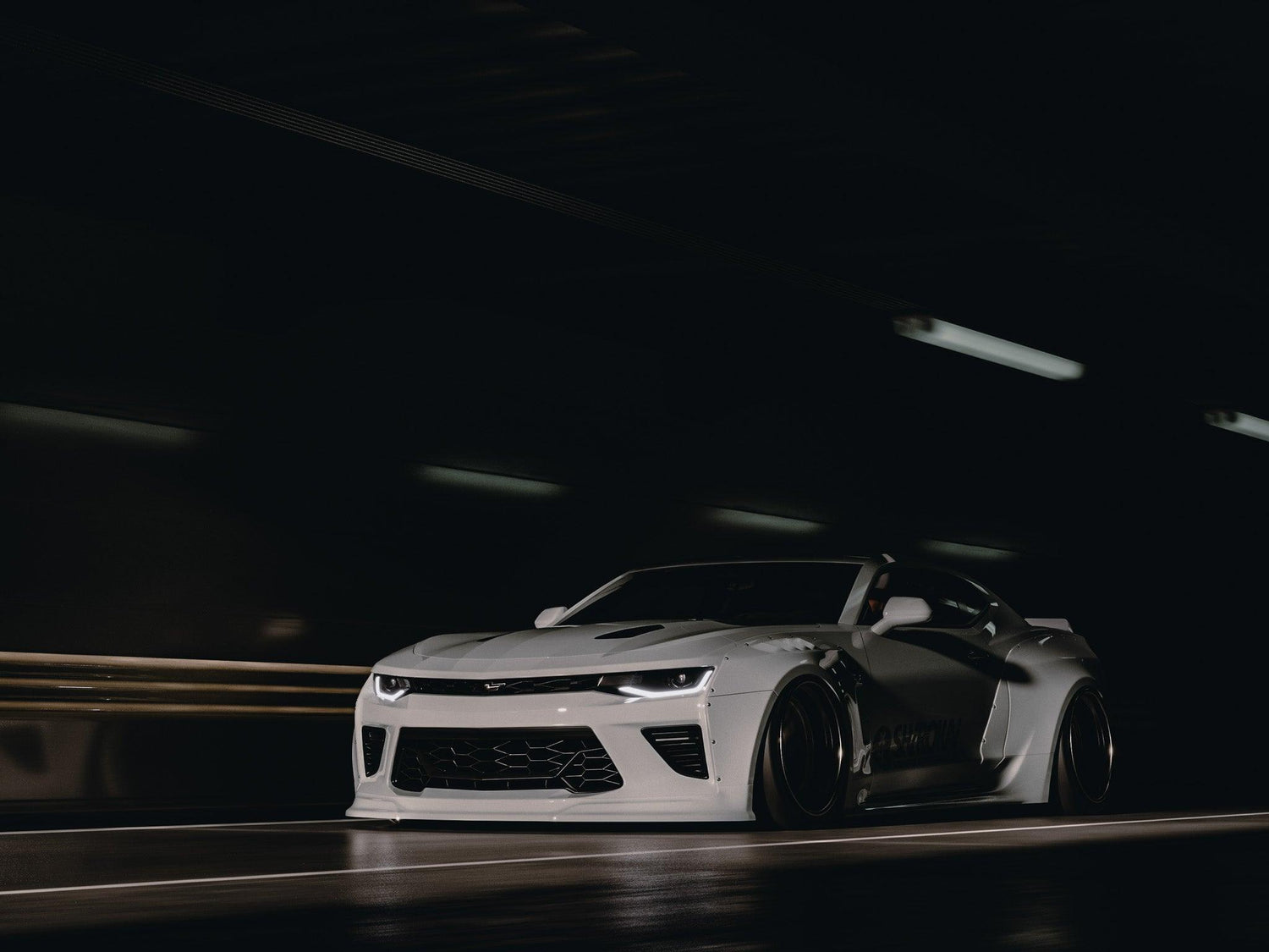 White Chevrolet Camaro 6th gen widebody kit SHIROKAI Stance lowered Chevy in dark tunnel