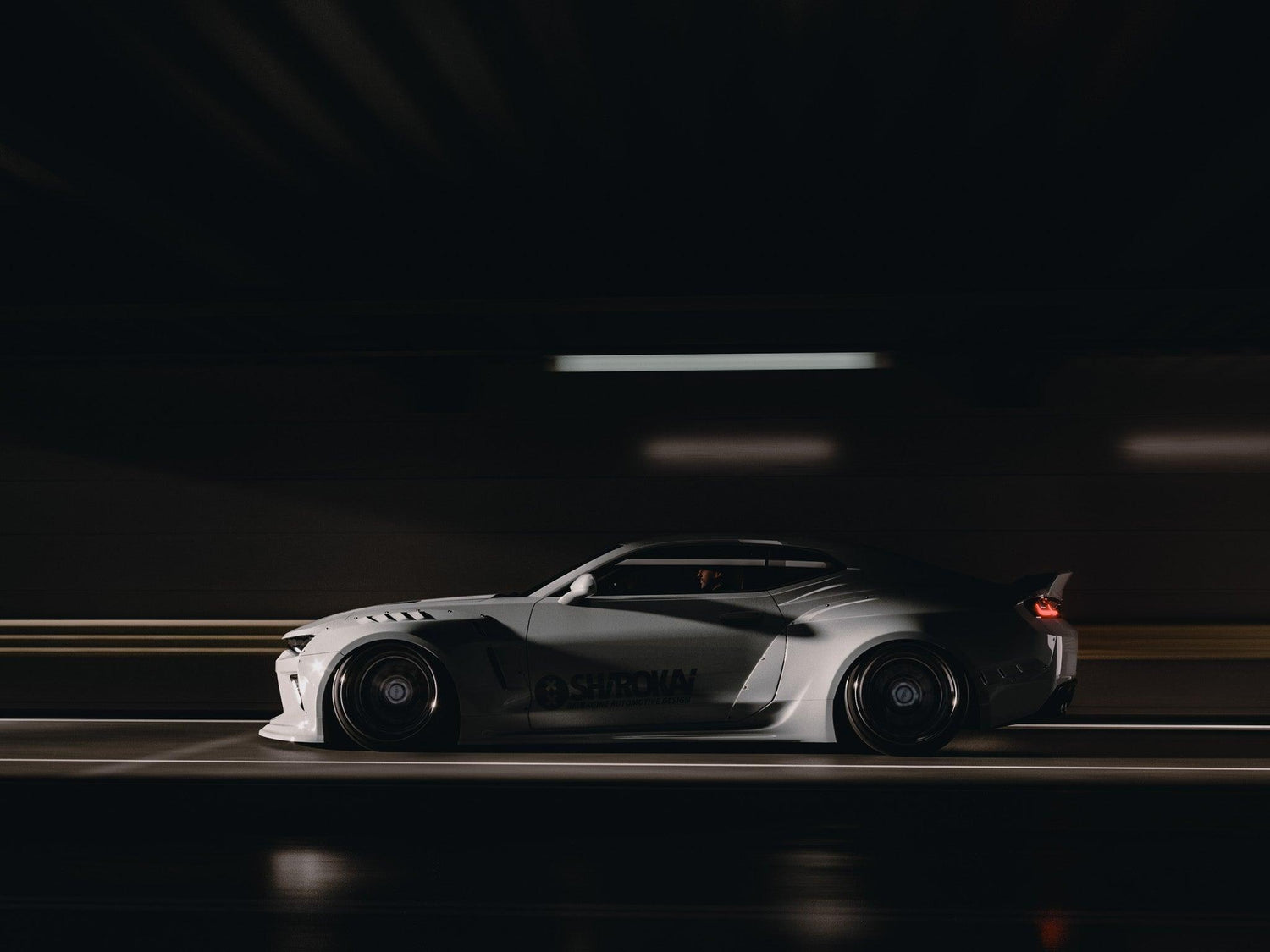 Chevrolet Camaro 6th gen widebody kit SHIROKAI Stance lowered Chevy in white racing on dark street