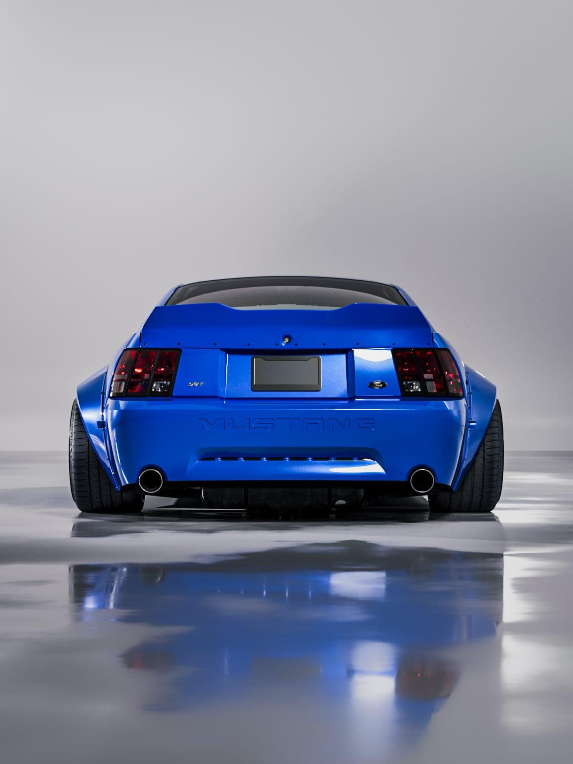 1999-2004 Mustang SN95 Cobra wide-body kit by SHIROKAI on blue Mustang rear view