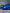 Blue 1999-2004 Mustang SN95 Cobra wide-body kit by SHIROKAI on rear side of car with black wheels