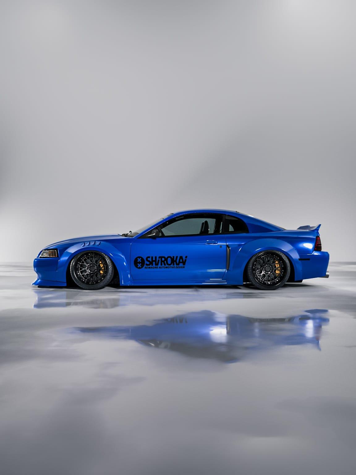 Blue 1999-2004 Mustang SN95 Cobra wide-body kit by SHIROKAI with sleek aerodynamic design