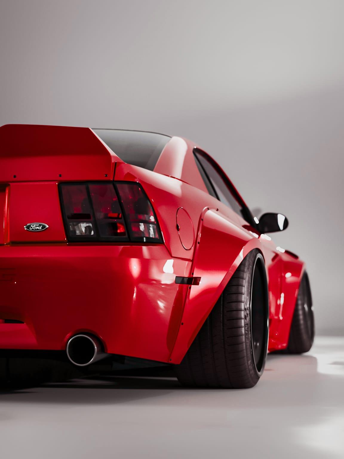 Red Ford Mustang with SHIROKAI 1999-2004 Mustang SN95 Cobra wide-body kit rear and side view
