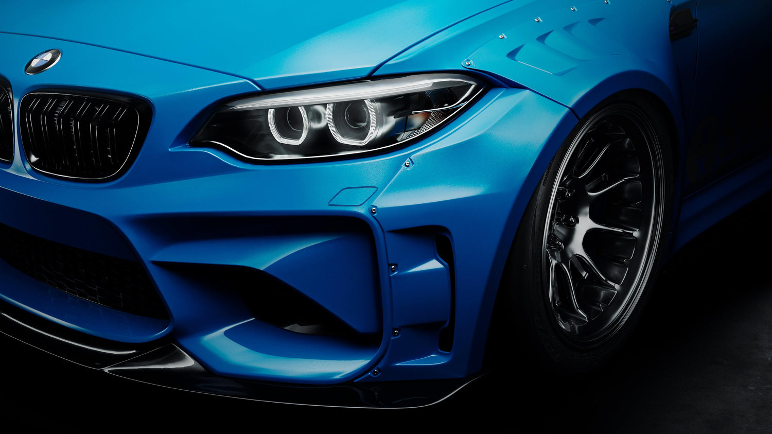 Close-up of a blue BMW M2 with 2015-2018 widebody kit SHIROKAI installed on front fender and bumper