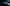 Blue BMW M2 2015-2018 with SHIROKAI widebody kit parked in dimly lit industrial setting
