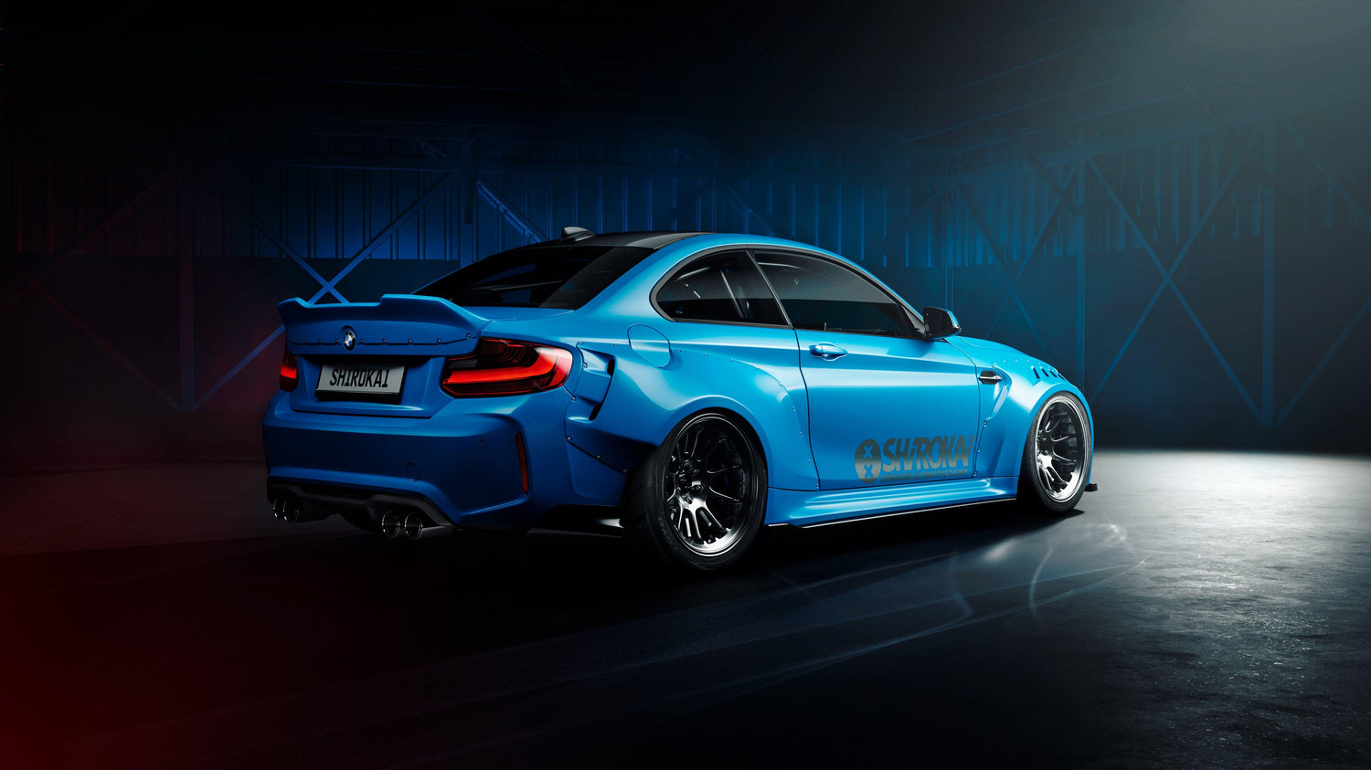 Blue BMW M2 2015-2018 with SHIROKAI widebody kit parked in dimly lit industrial setting