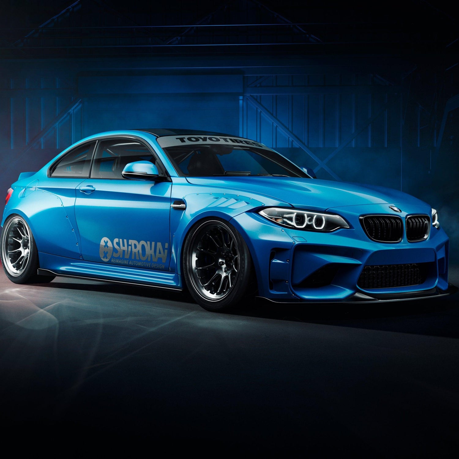 Blue BMW M2 2015-2018 with widebody kit SHIROKAI installed in a dark studio setting