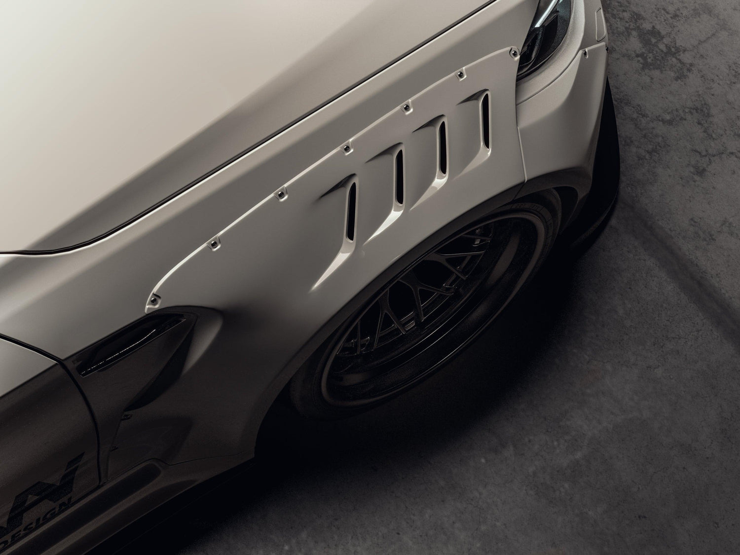 Close-up of BMW M2 2015-2018 widebody kit SHIROKAI installed on front fender with vents and black wheel