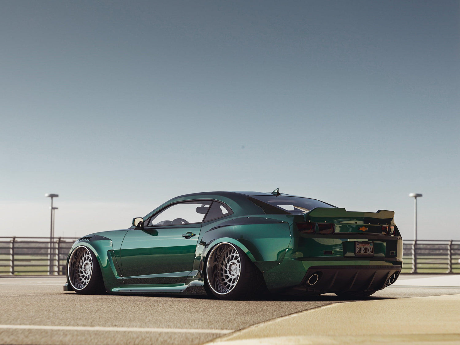 Green Chevrolet Camaro SS 2010-2013 widebody kit SHIIROKAI overfenders on a customized sports car
