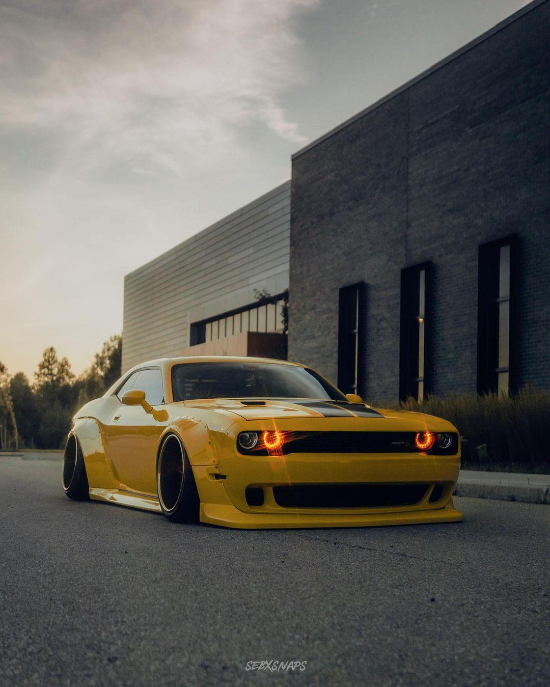 Yellow Dodge Challenger with SHIROKAI widebody kit parked on street at dusk Dodge Challenger HELLCAT SHIROKAI widebody kit