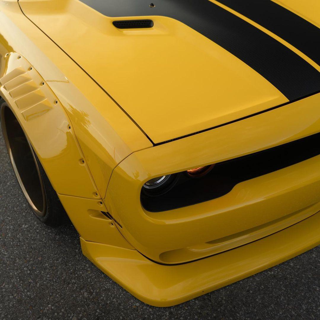 Yellow Dodge Challenger with HELLCAT SHIROKAI widebody kit featuring aggressive front fender flares and black racing stripes