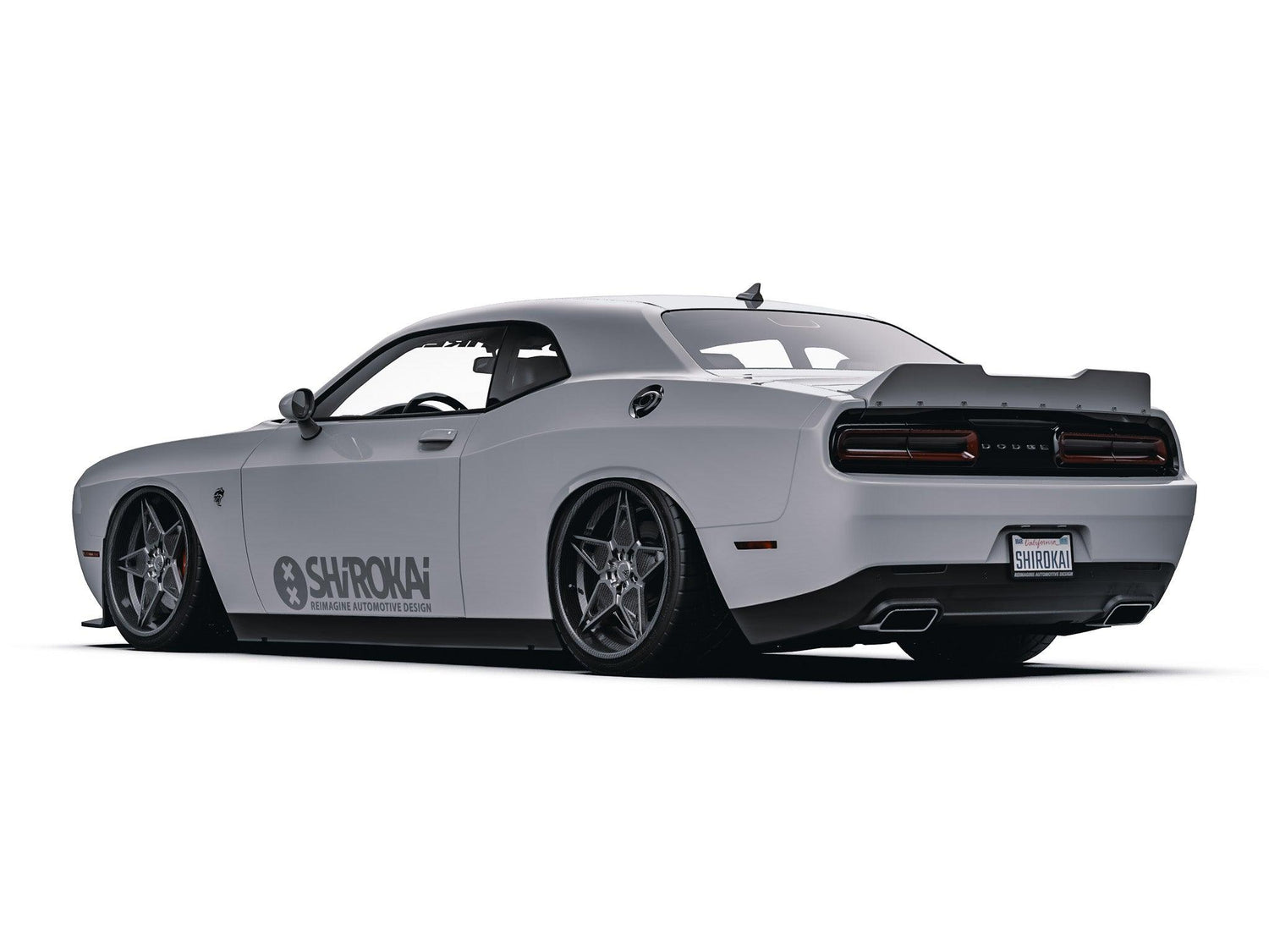 White Dodge Challenger with SHIROKAI ducktail spoiler and custom wheels parked on white background