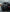 Matte black Dodge Charger with Dodge Charger LD widebody kit SHIROKAI on wet pavement