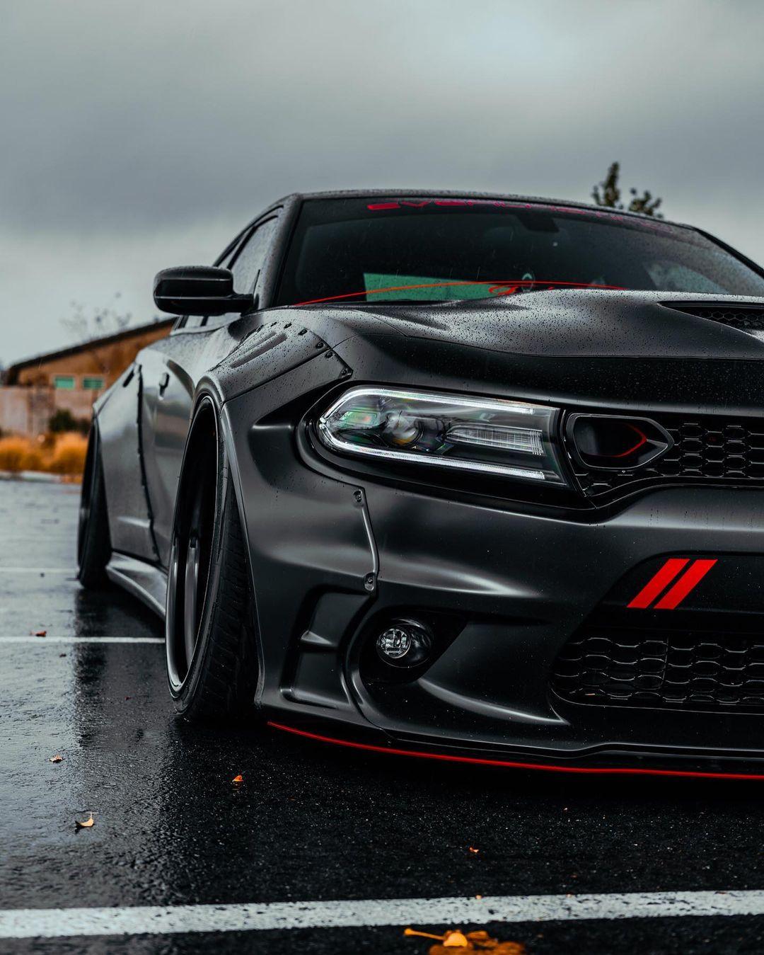 Matte black Dodge Charger with Dodge Charger LD widebody kit SHIROKAI on wet pavement