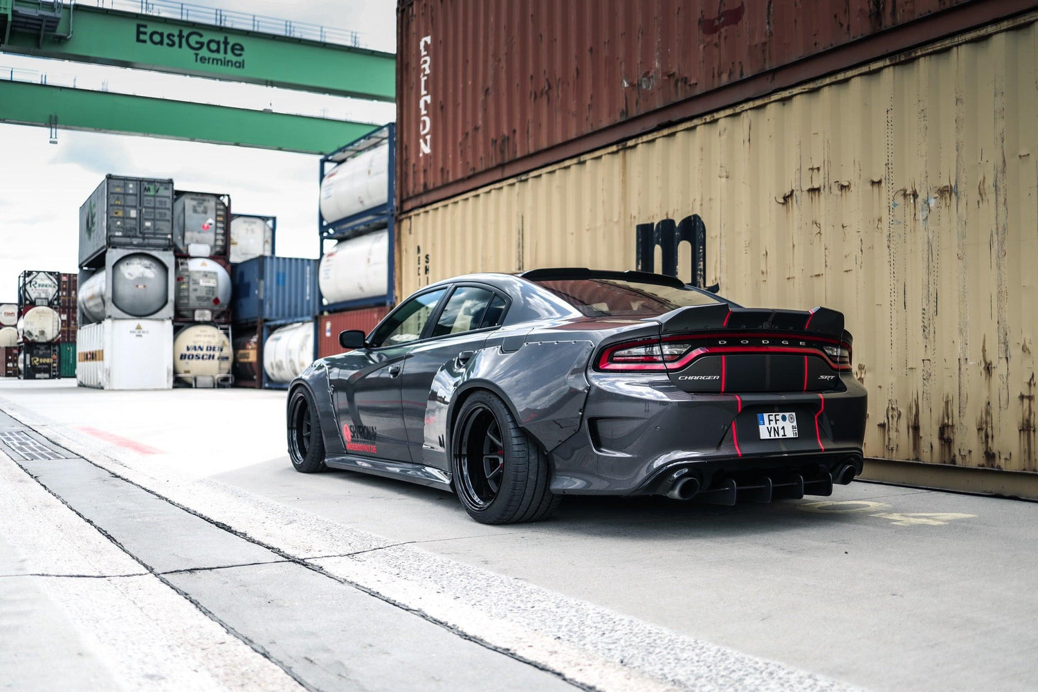 Dodge Charger fitted with Dodge Charger LD widebody kit SHIROKAI in an industrial shipping container area