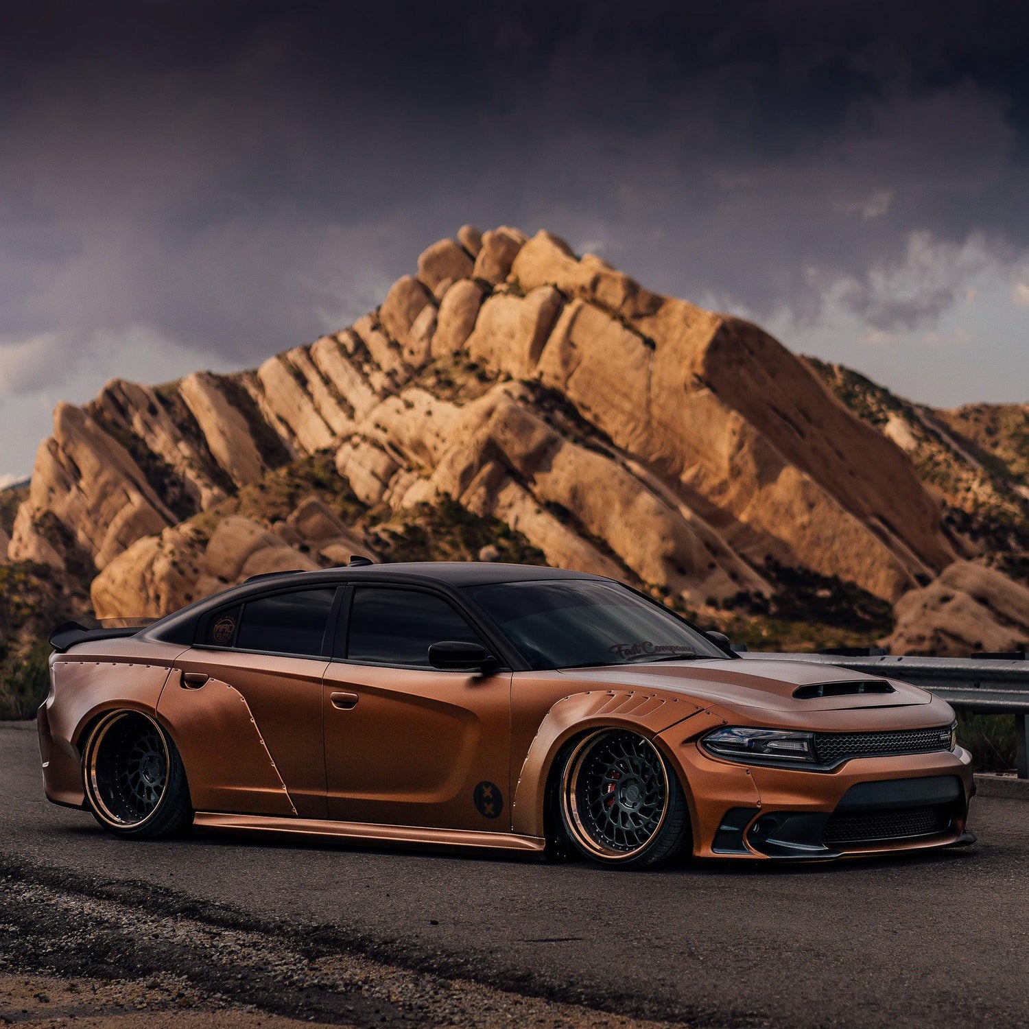 Bronze Dodge Charger with Dodge Charger LD widebody kit SHIROKAI parked by rocky mountain landscape