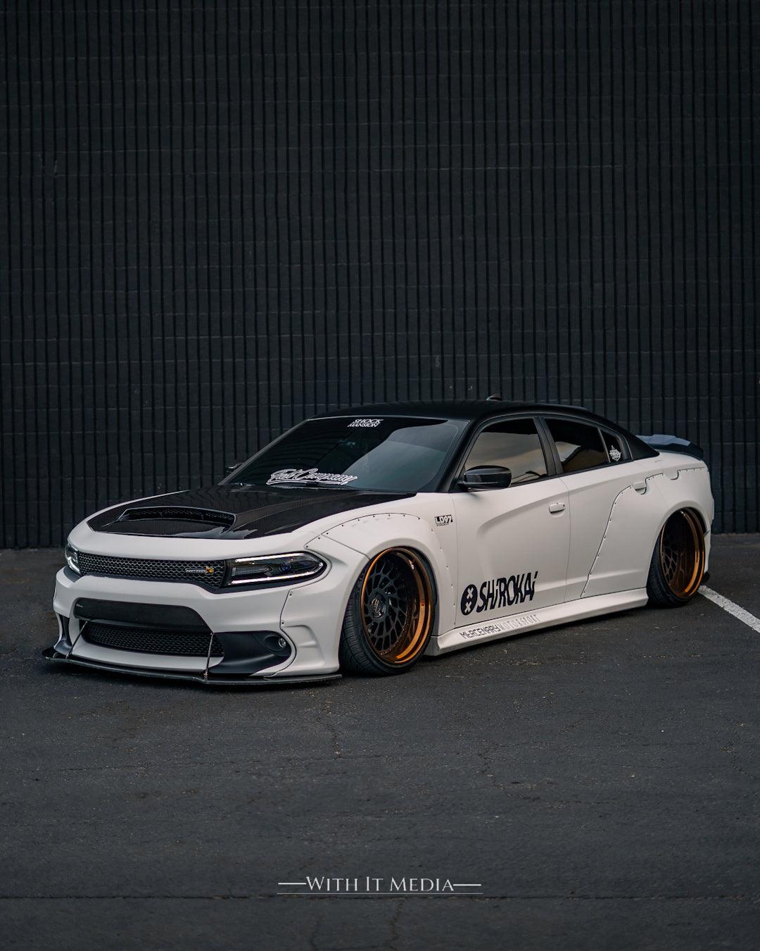 White Dodge Charger with custom black and gold wheels featuring Dodge Charger LD widebody kit SHIROKAI in a parking lot