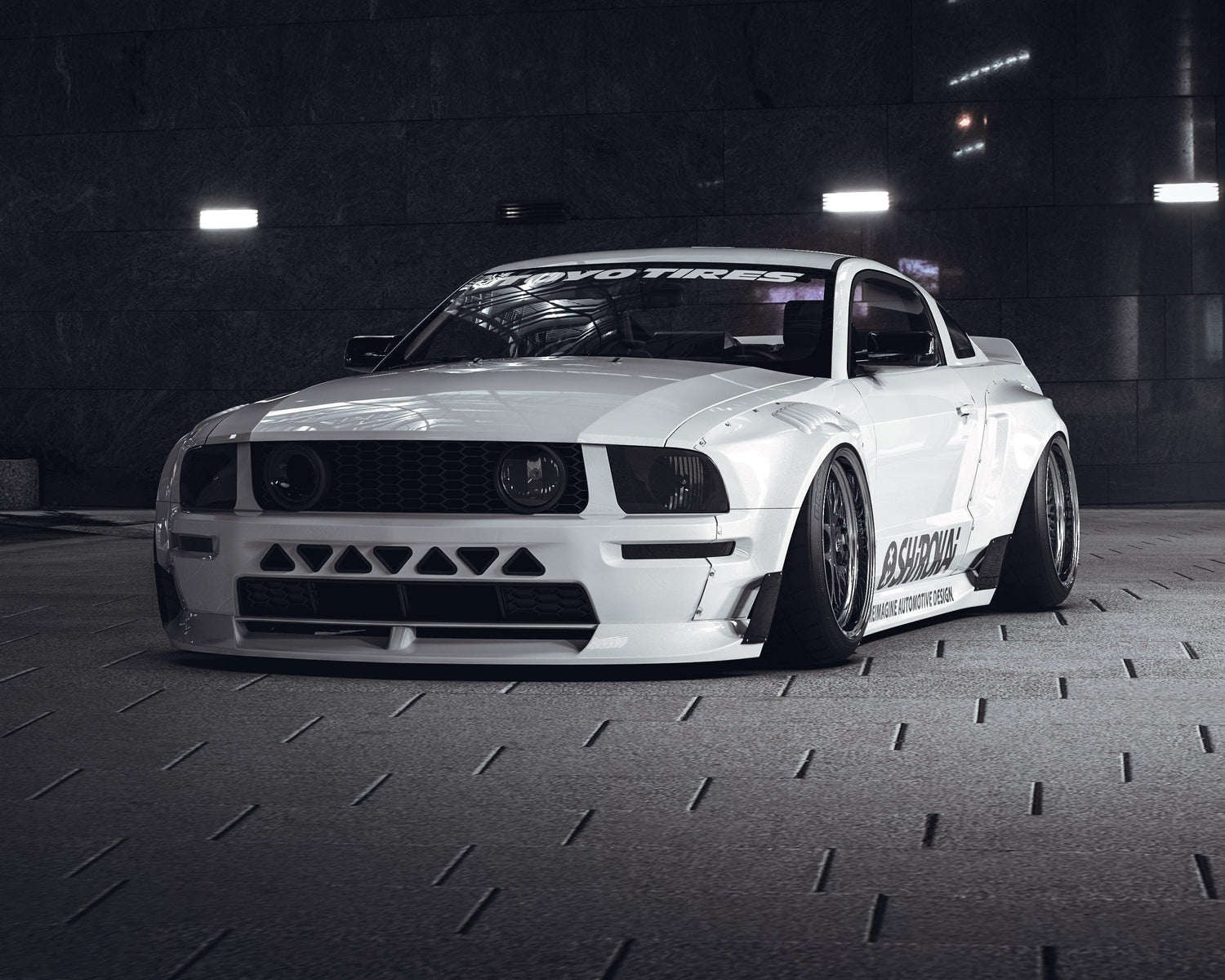 White Ford Mustang S197 with SHIROKAI widebody kit parked in dimly lit urban setting