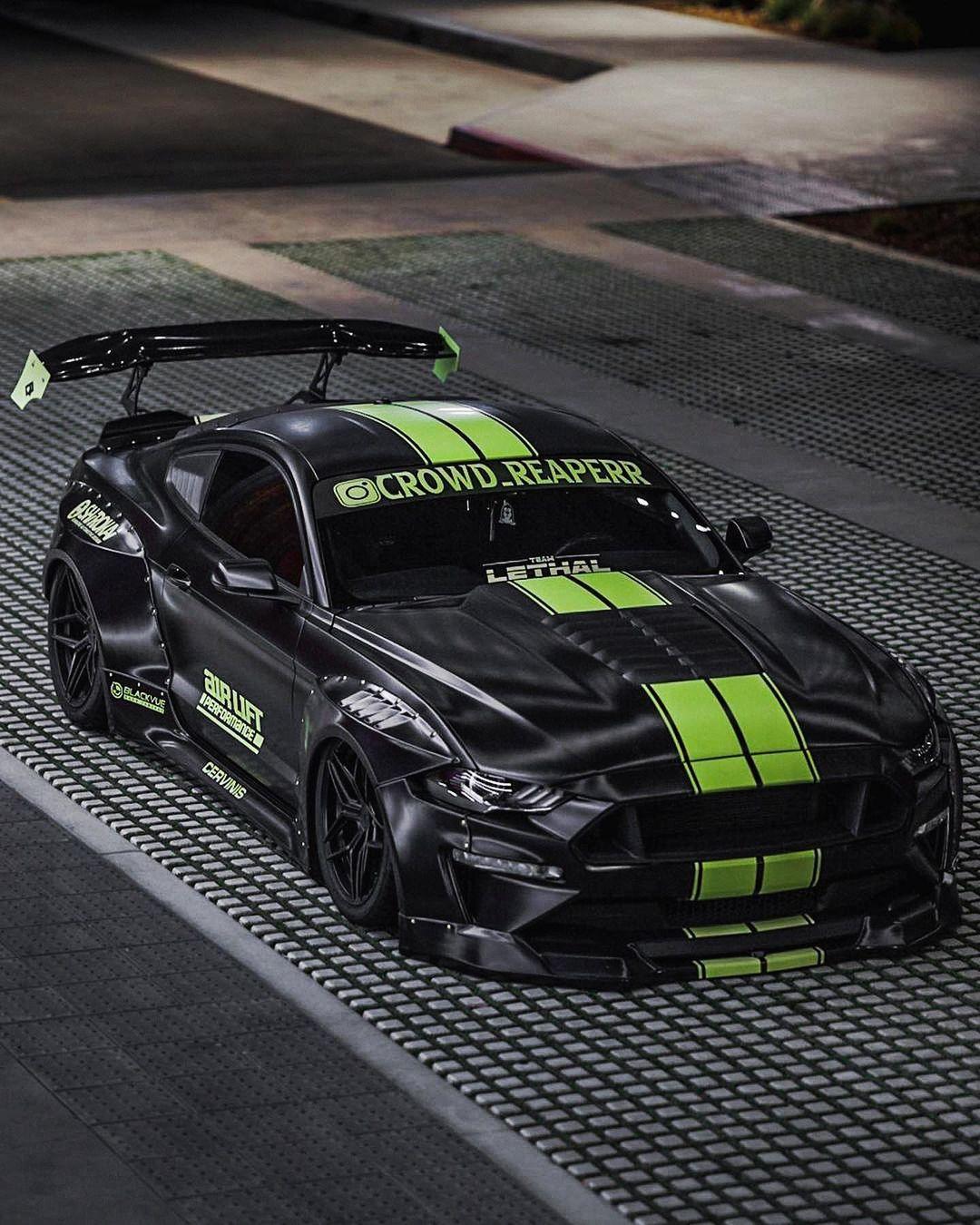 Ford Mustang S550 widebody kit SHIROKAI on black sports car with green racing stripes and large rear wing