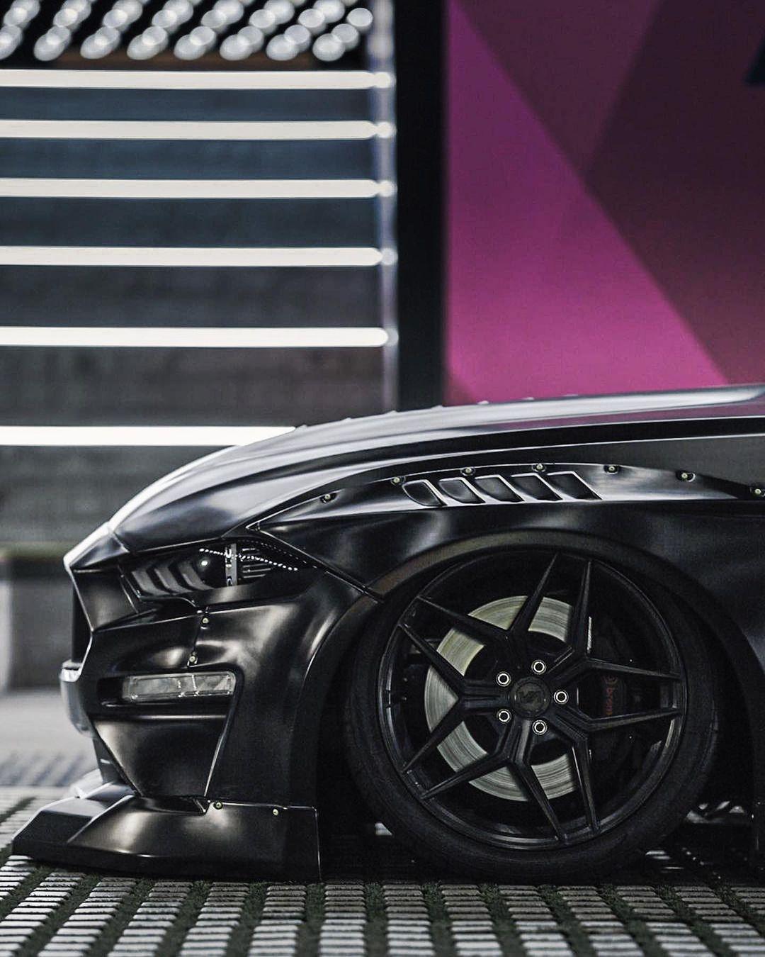 Ford Mustang S550 widebody kit SHIROKAI installed on a black Mustang with aggressive front fender flare and custom wheel