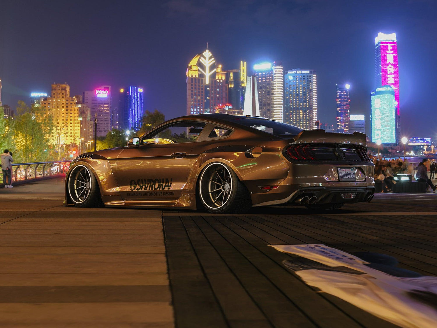 Ford Mustang S550 widebody kit SHIROKAI installed on bronze car with lowered stance at night cityscape