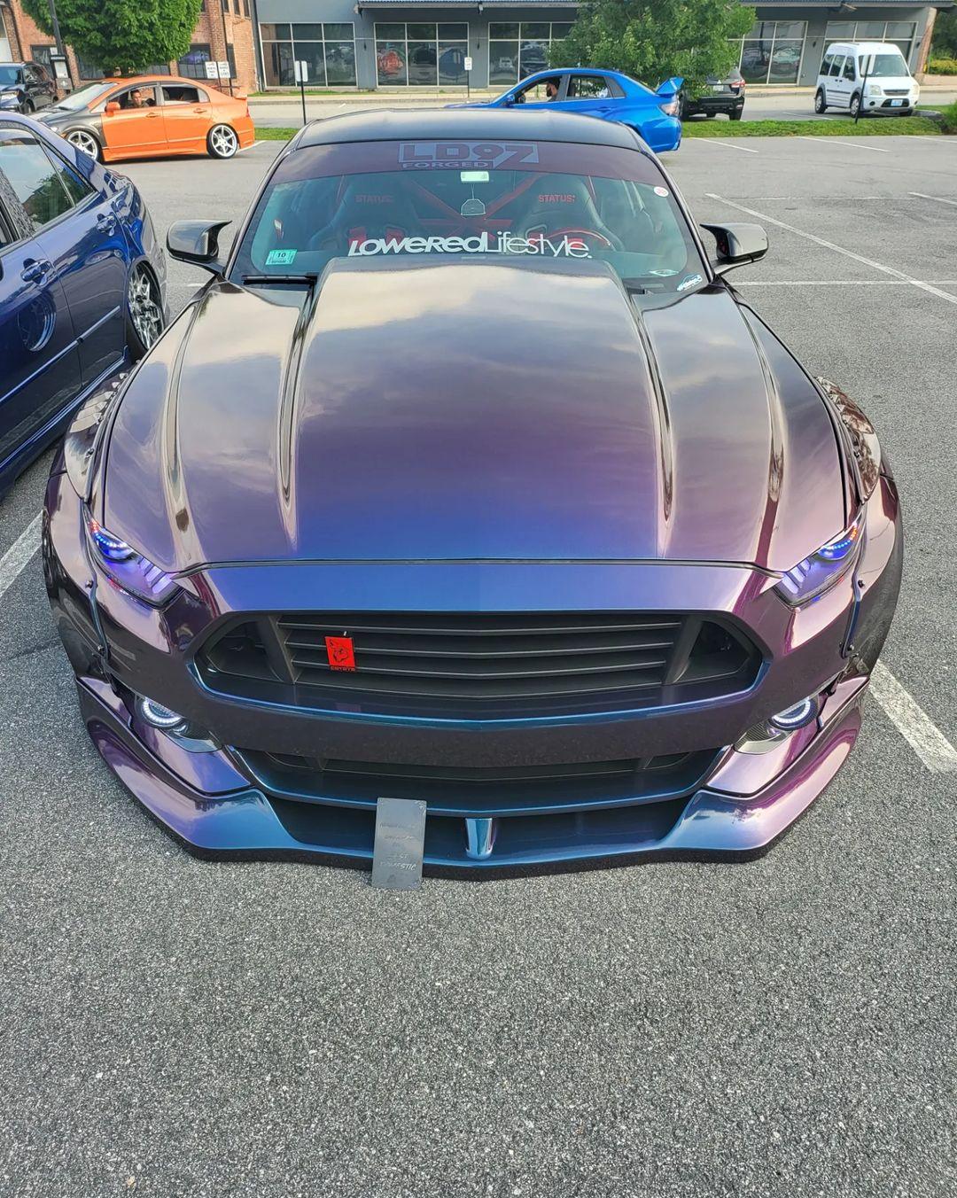 Front view of a Ford Mustang S550 widebody kit SHIROKAI with iridescent paint and aggressive styling