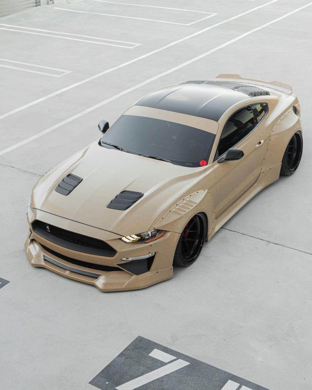 Ford Mustang S550 widebody kit SHIROKAI installed on beige sports car parked in empty lot