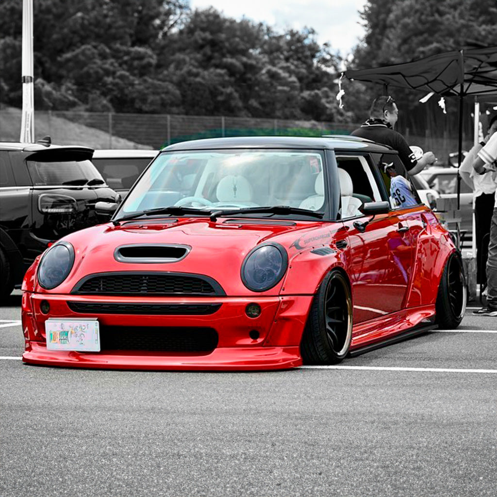 Red Mini Cooper S R53 with SHIROKAI widebody kit parked at a car meet with lowered stance