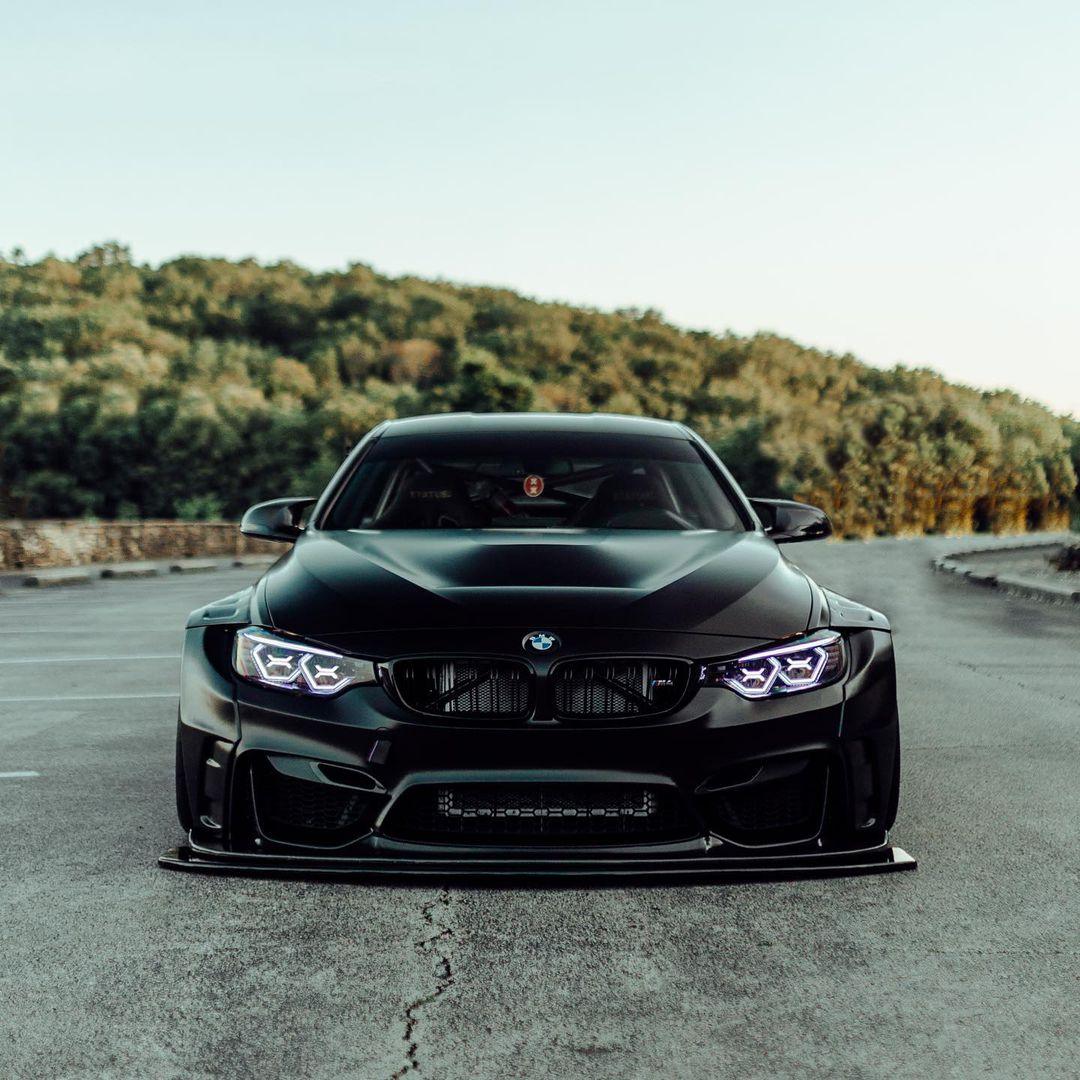 Black BMW M4 F82 2014-2020 with widebody kit for BMW M4 F82 2014-2020 SHIROKAI stance bimmer on paved road