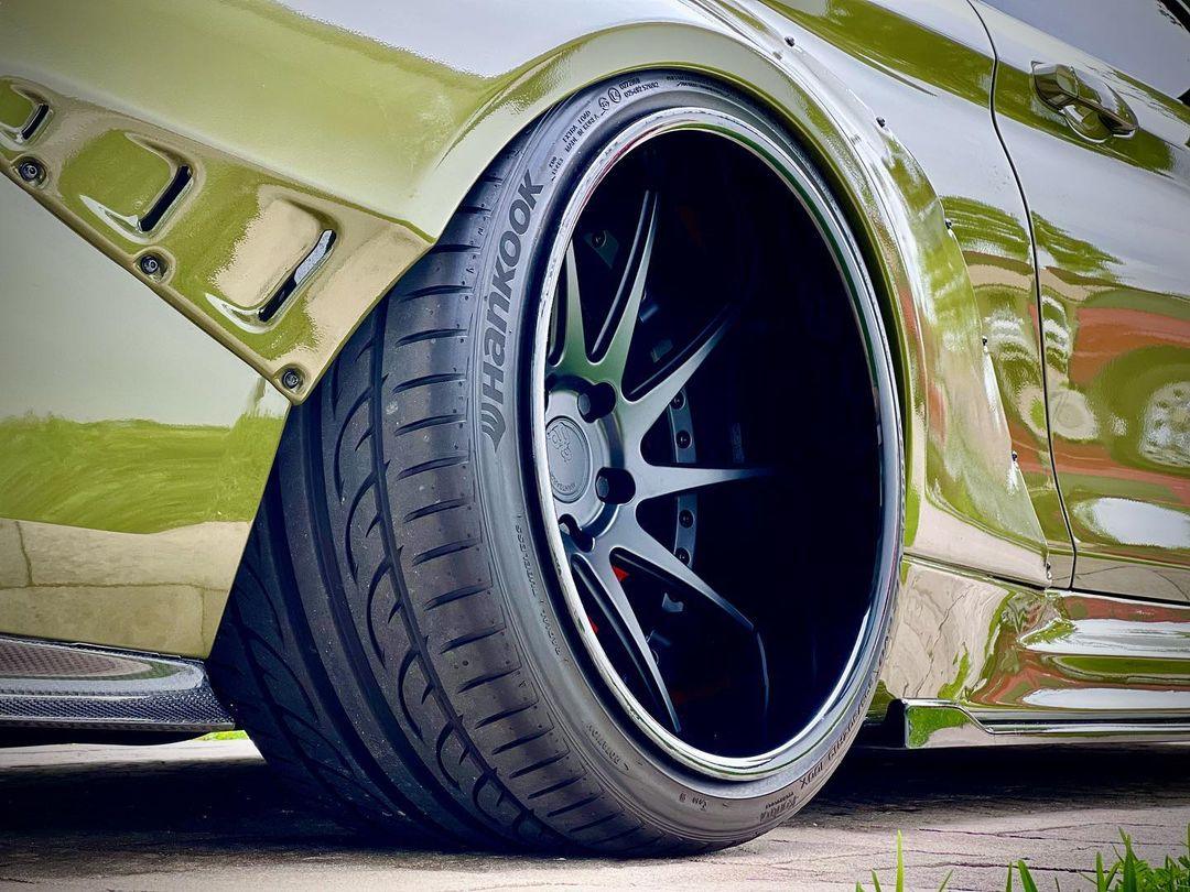 Close-up of widebody kit for BMW M4 F82 2014-2020 SHIROKAI stance bimmer showing flared fender and custom wheel