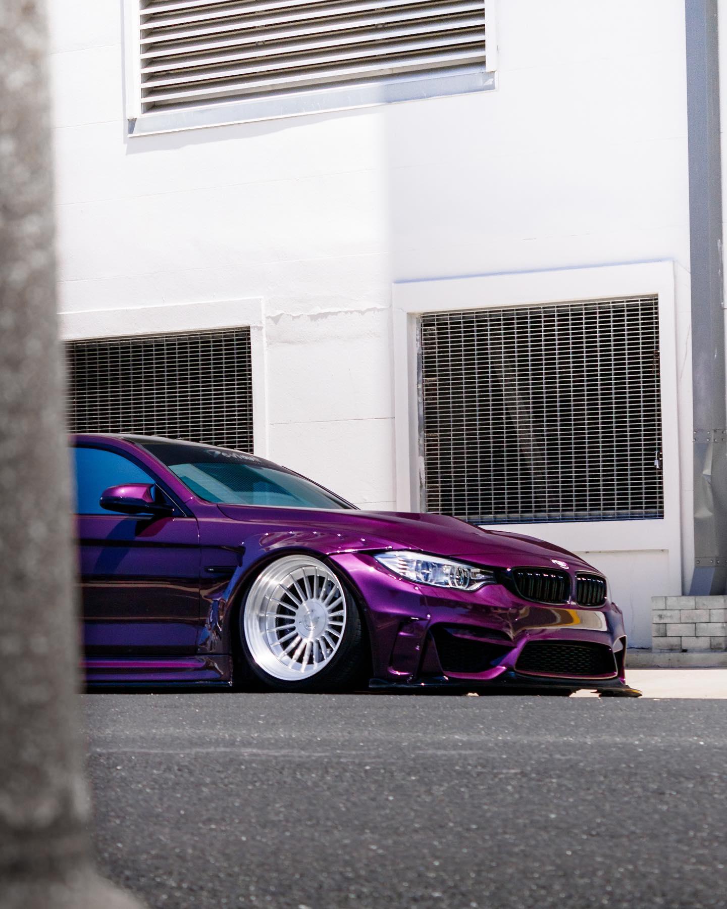Purple BMW M4 F82 2014-2020 with widebody kit for BMW M4 F82 2014-2020 SHIROKAI stance bimmer parked by white building
